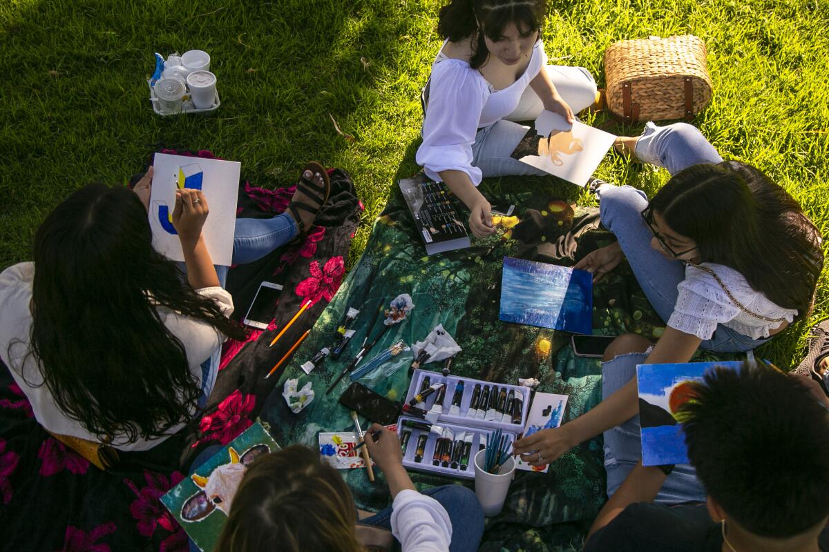 Friends meet for a painting session on the grass in Echo Park. 