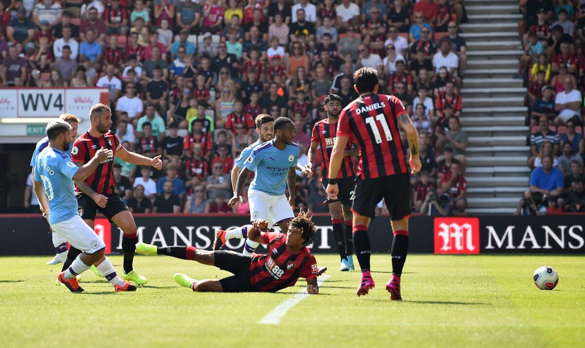 Manchester City's Argentinian striker Sergio Aguero, left, scores against Bournemouth on Aug. 25.