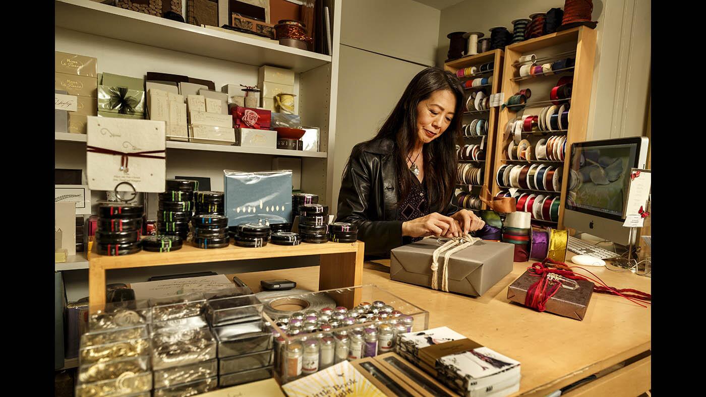 Wanda Wen, founder and creative director of upscale stationery and paper arts studio Soolip, wraps gifts at her shop in West Hollywood.