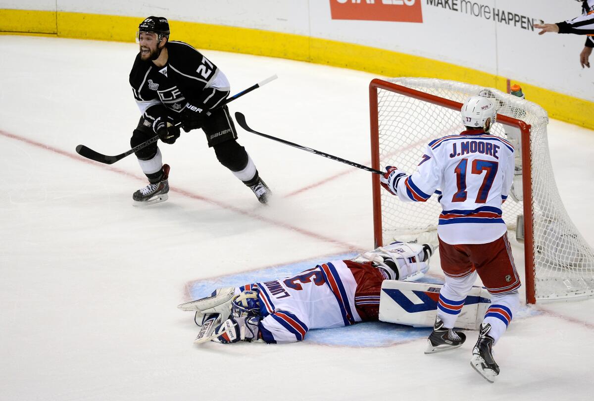 Alec Martinez celebrates after scoring against New York Rangers goalie Henrik Lundqvist in double overtime to clinch the 2014 Stanley Cup title.