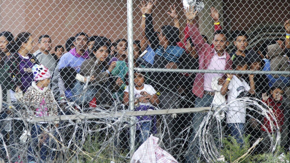 Central American migrants wait for food in a pen erected by U.S. Customs and Border Protection to process a surge of migrant families and unaccompanied minors in El Paso, Texas on March 27.