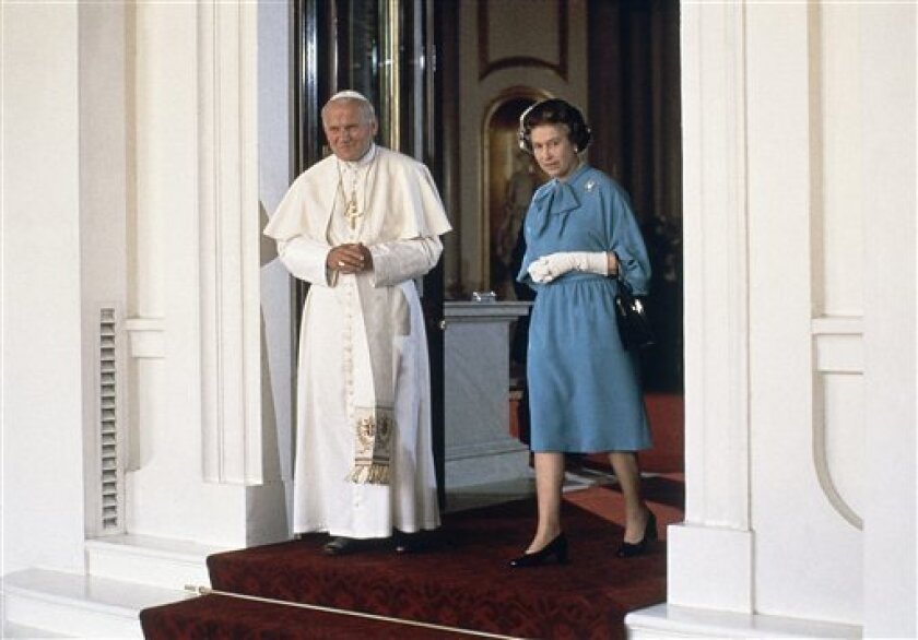 FILE - In this Friday, May 28, 1982 file photo, Pope John Paul II walks with Britain’s Queen Elizabeth II at Buckingham Palace in London. Pope John Paul II sought to overcome centuries of distrust when he became the first pope to visit British shores in 1982, preaching reconciliation between the Vatican and Anglicans even as British troops battled Catholic Argentines in the Falklands. His successor, Benedict XVI, can expect a far cooler _ if not at times downright hostile _ reception in his upcoming state visit. (AP Photo/pool, file)