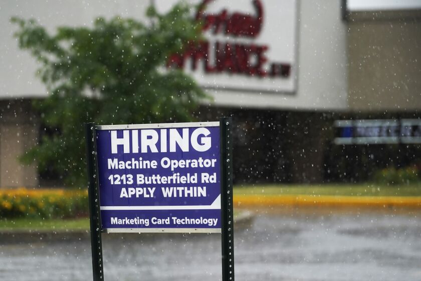 FILE - A hiring sign is displayed in Downers Grove, Ill., on June 24, 2021. The number of Americans applying for unemployment benefits fell to a fresh pandemic low last week, Thursday, Nov. 4, another sign the job market is healing after last year’s coronavirus recession. Jobless claims dropped by 14,000 to 269,000 last week. (AP Photo/Nam Y. Huh, File)