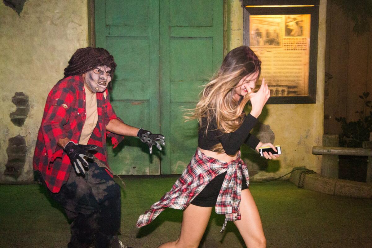 A Knott's Scary Farm character scares an unsuspecting visitor. The park was sued by a guest who alleged she was assaulted last year by a character in a Halloween maze.
