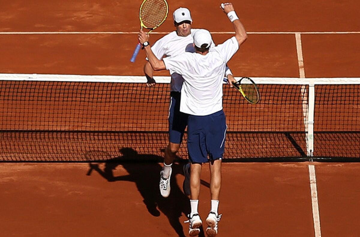 Twin brothers Bob and Mike Bryan celebrate after winning their Davis Cup doubles match against Britain's Colin Fleming and Dominic Inglot on Saturday.