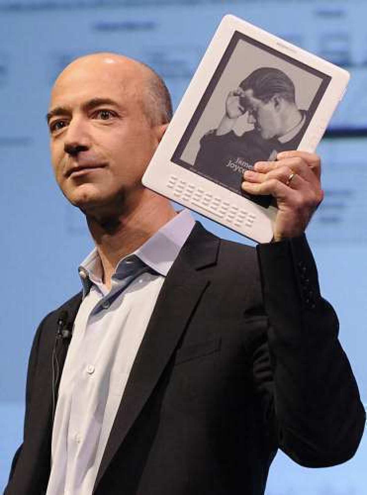Amazon.com founder and CEO Jeff Bezos, holding a Kindle, says his team of ¿undersea pros¿ had found the engines that helped launch the Apollo 11 mission.