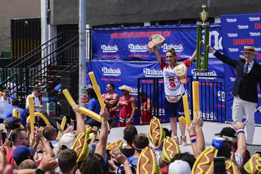 Miki Sudo celebrates after winning the women's division of Nathan's Famous Fourth of July hot dog eating contest 