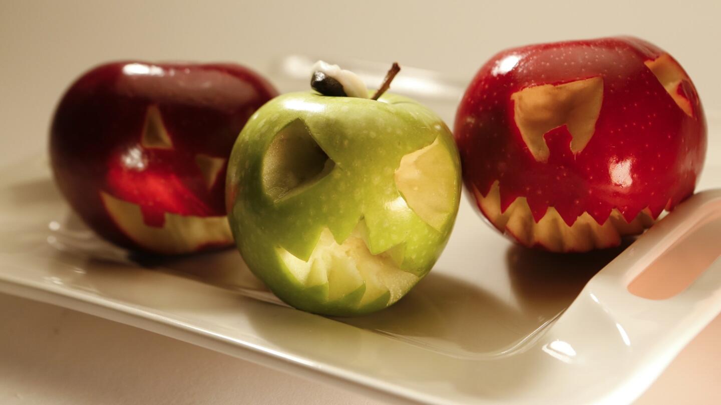 Carved fruits and veggies as jack-o'-lanterns