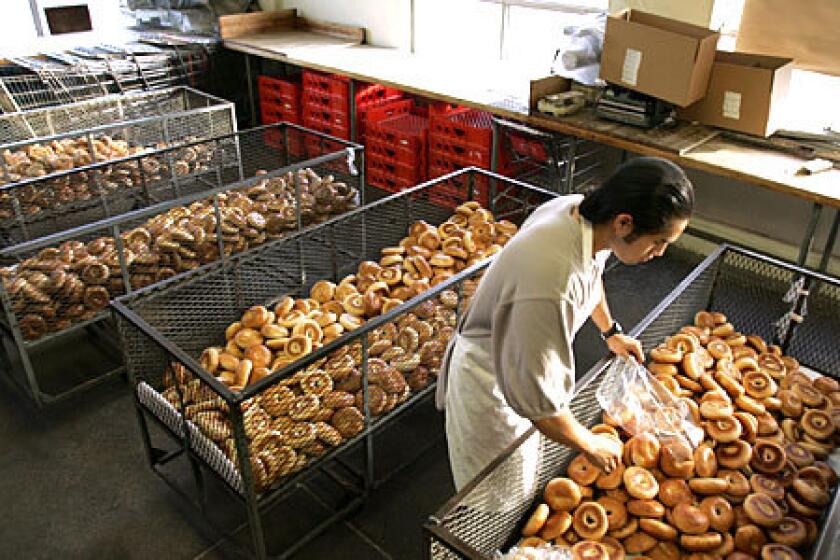 GOLDEN GLOW: Bagels fresh from the oven are prepared for shipping to customers at Brooklyn Bagel, a 55-year-old L.A. bakery.