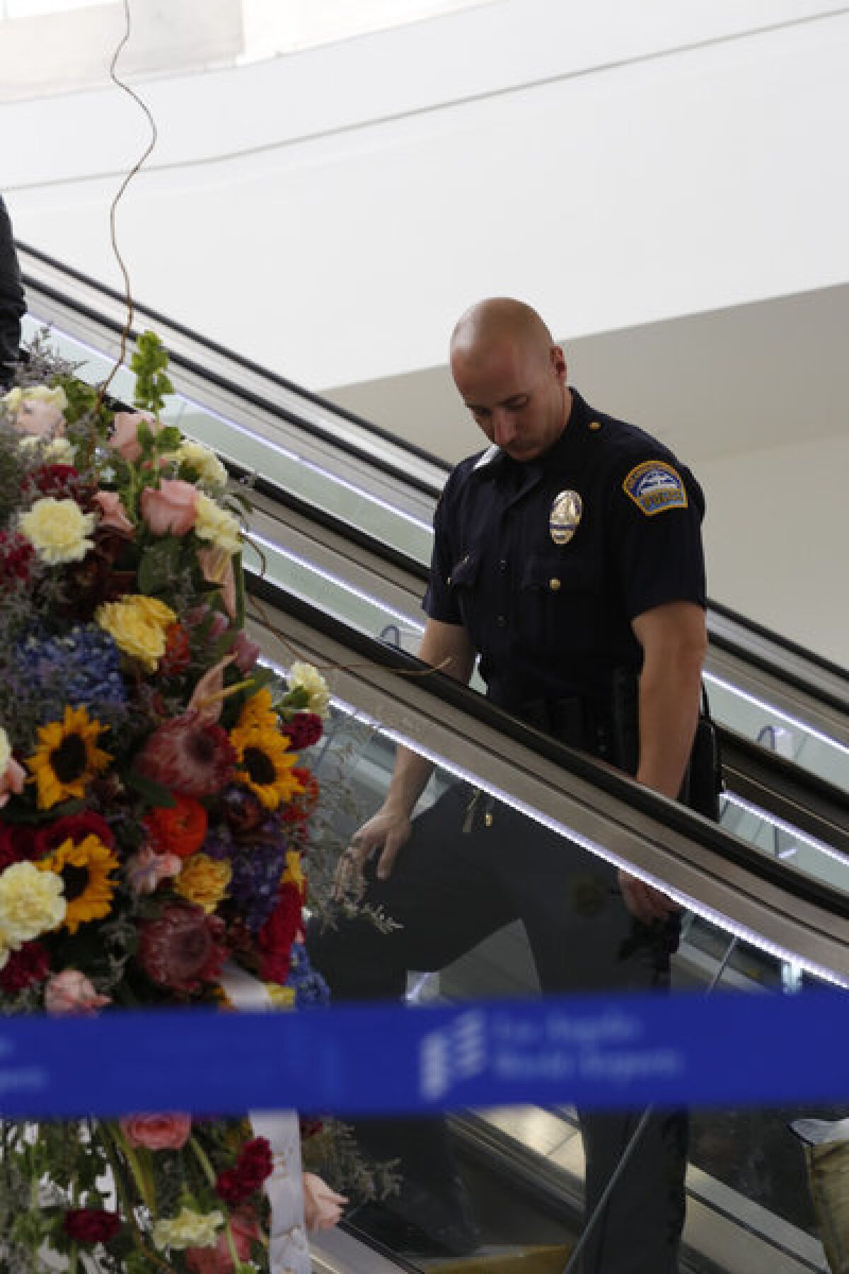 Flowers for slain TSA agent Gerardo Hernandez at LAX Terminal 3.