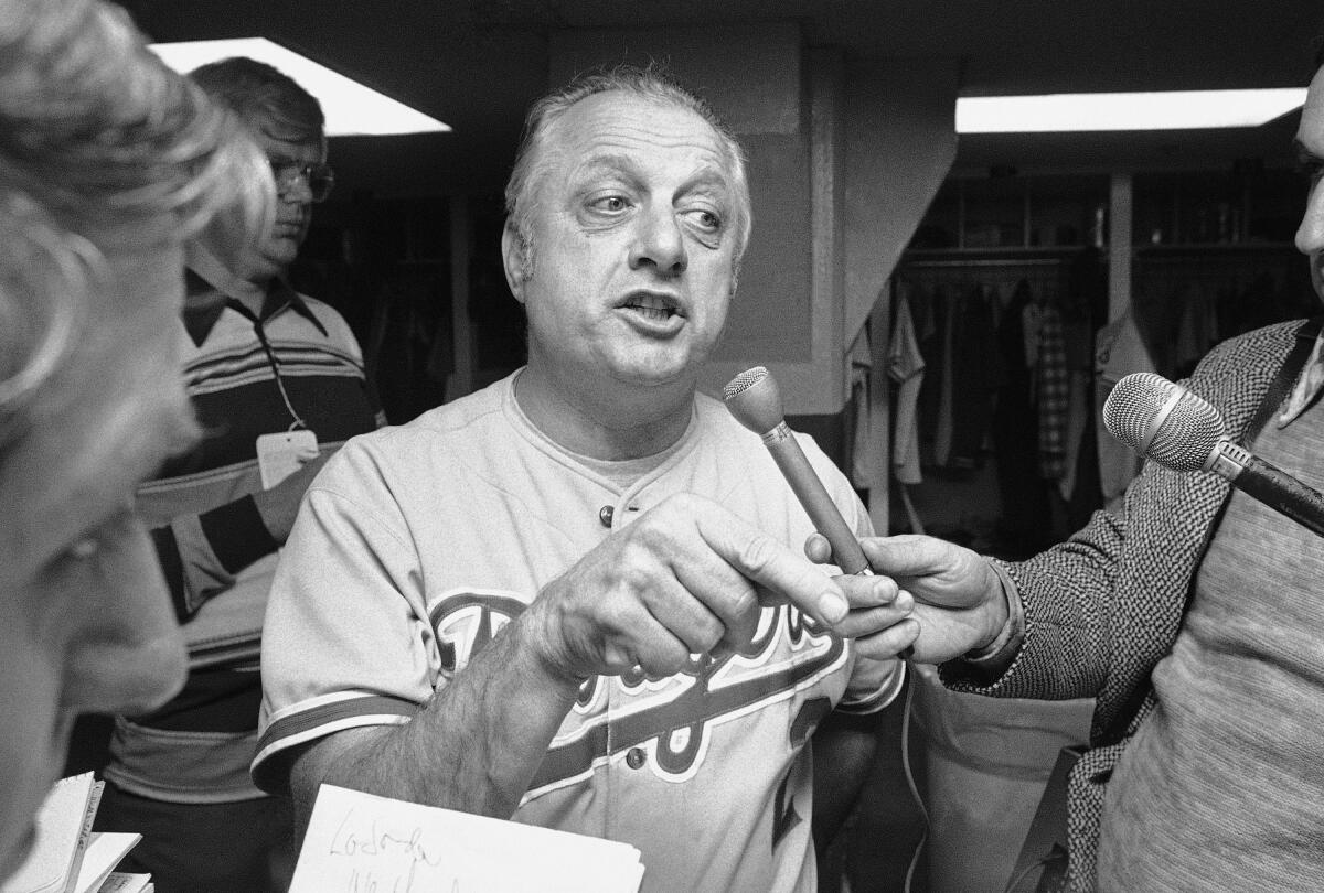 Dodgers manager Tommy Lasorda talks to reporters after his team lost the first game of the World Series, 4-3.