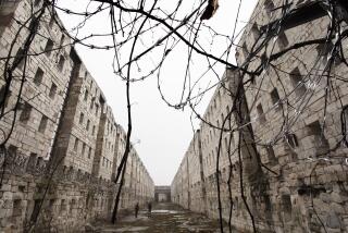 In this Feb. 13, 2020 photo, concertina wire and vines line the stone walls of a former cell block at Sing Sing Correctional Facility in Ossining, N.Y. The hollowed-out building used to house cells for 1,200 men on six tiers and runs well longer than a football field. A not-for-profit group is planning to open the Sing Sing Prison Museum in 2025. Their mission will be to provide a historical picture of incarceration in America while telling the story of one of the county's most well-known prisons. (AP Photo/Mark Lennihan)