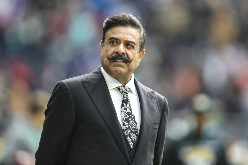 FILE - Jacksonville Jaguars owner Shad Khan on the field before an NFL football game against the Miami Dolphins at Tottenham Hotspur Stadium in London, Sunday, Oct. 17, 2021. Over the past 100 years, around 110 men and a handful of women have owned controlling portions of NFL teams. Of that select group, all but two have been white. . (AP Photo/Gary McCullough, File)