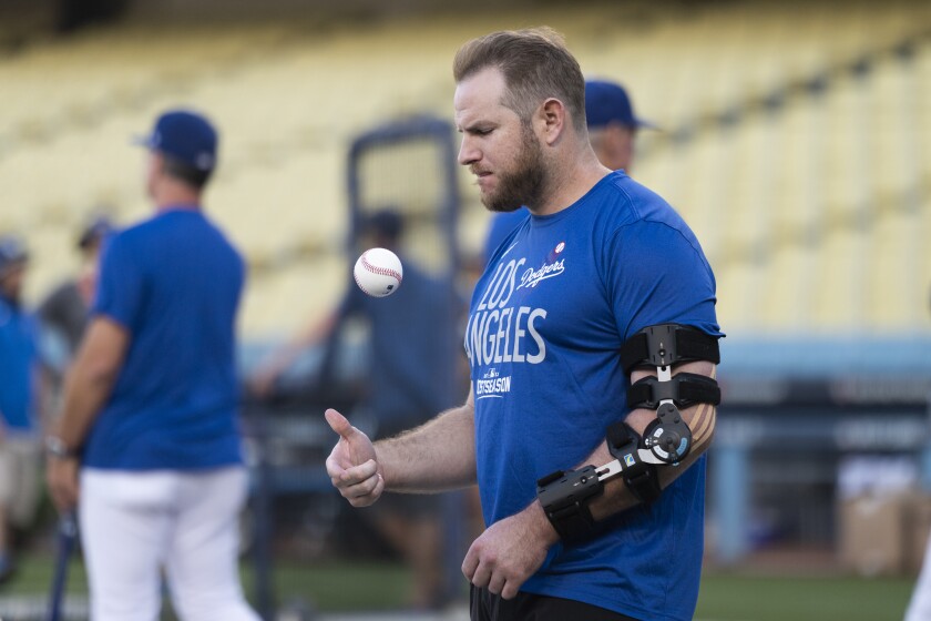 Dodgers infielder Max Muncy tosses a ball around during a team practice session on Tuesday.