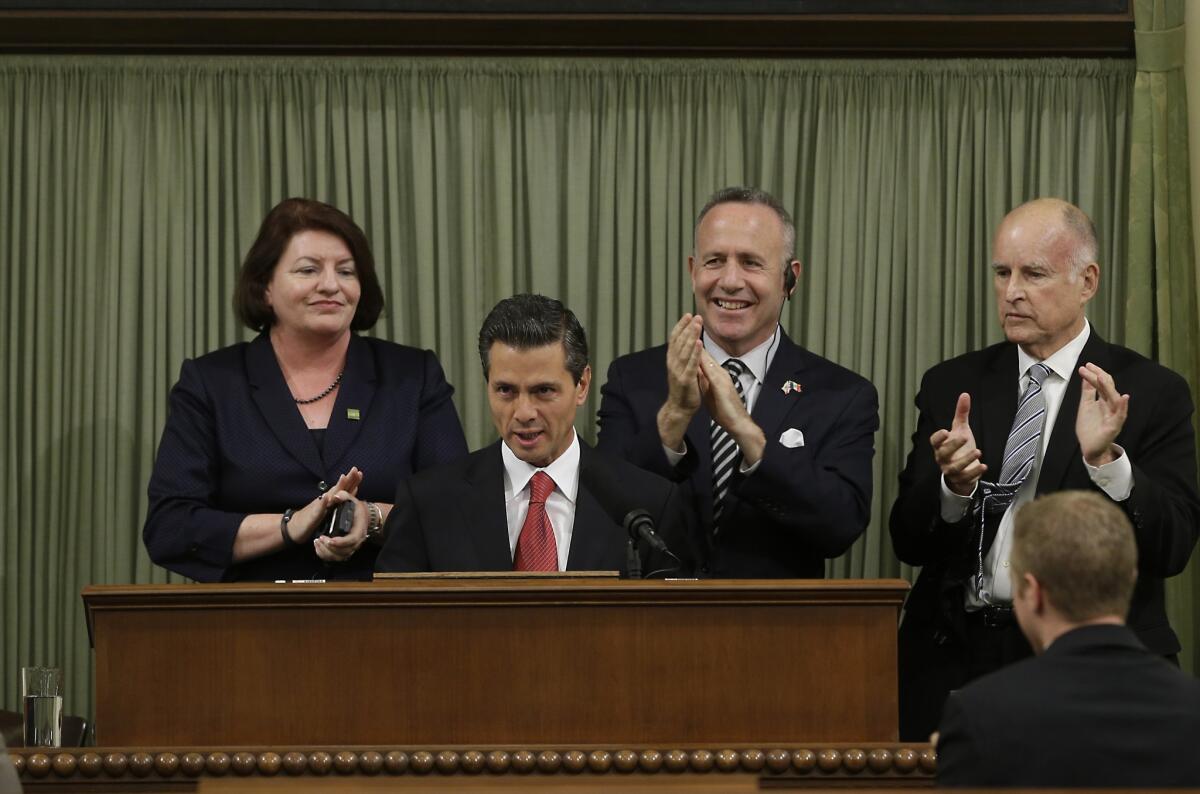 Mexican President Enrique Peña Nieto is applauded by, from left, Assembly Speaker Toni Atkins (D-San Diego), Senate President Pro Tem Darrell Steinberg (D-Sacramento) and Gov. Jerry Brown at a joint convention of the state Legislature.