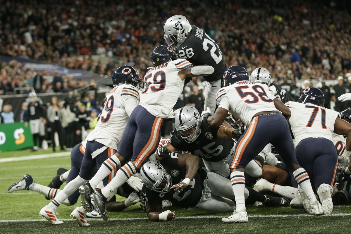 Oakland Raiders running back Josh Jacobs leaps over the line to score a touchdown during the second half of a 24-21 victory over the Chicago Bears.