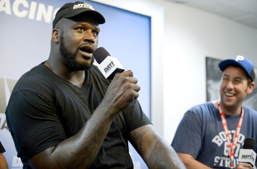 Shaquille O'Neal, left, and fellow grand marshal Adam Sandler take part in a news conference at Daytona International Speedway.