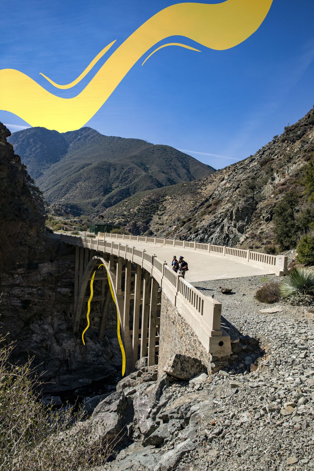 Hikers take in the San Gabriel River canyon view on the Bridge to Nowhere.
