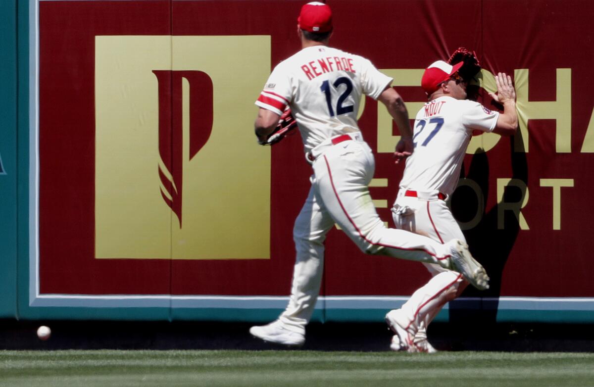 Angels center fielder Mike Trout runs into the center-field wall while attempting to catch a ball.