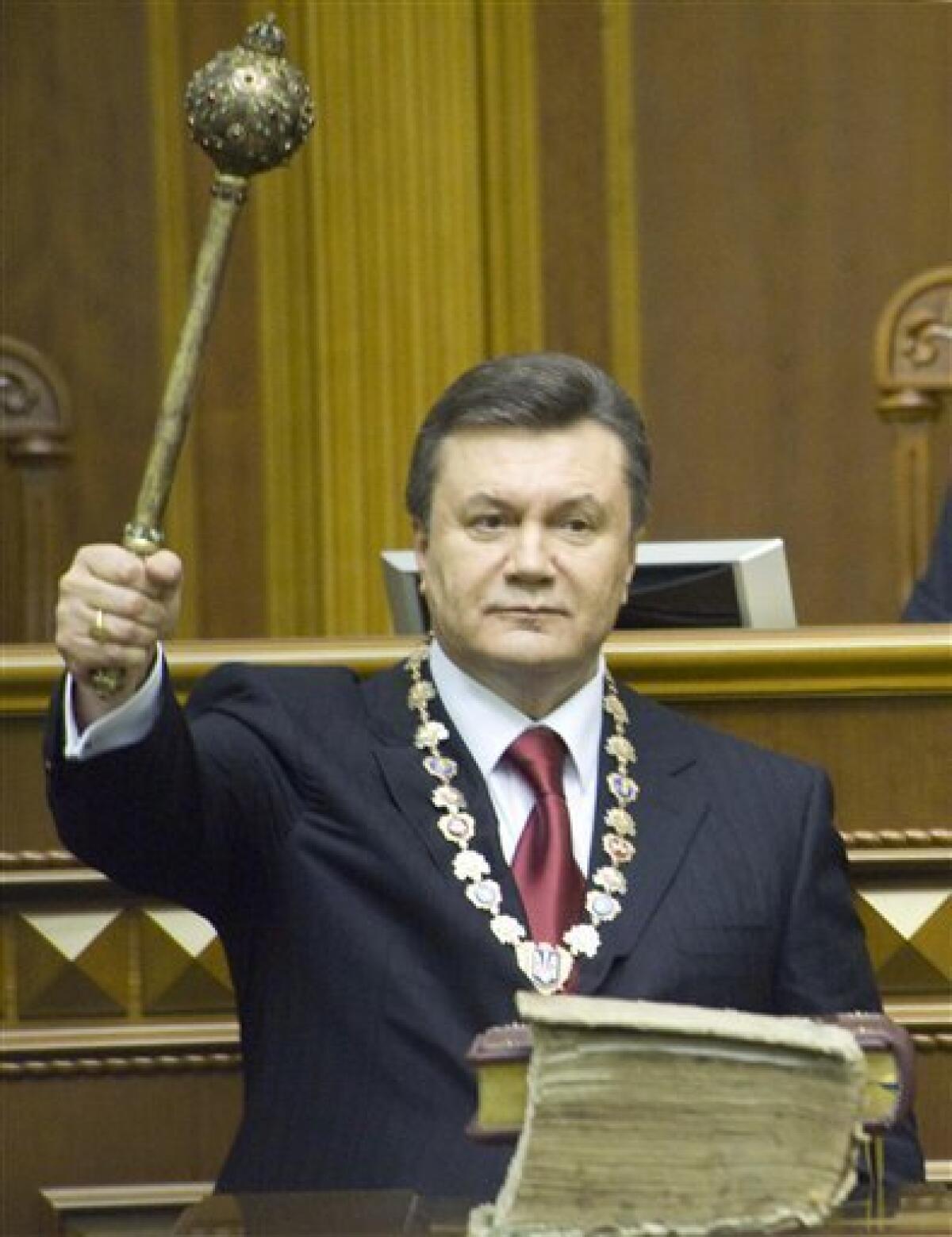 Ukraine's President Viktor Yanukovych holds a Bulava, a historical symbol of power, after he taking oath in the parliament in Kiev, Ukraine, Thursday, Feb. 25, 2010. Viktor Yanukovych has been inaugurated as Ukraine's President, five years after his first bid failed amid massive protests over vote fraud. (AP Photo/Anastasia Sirotkina, Pool)