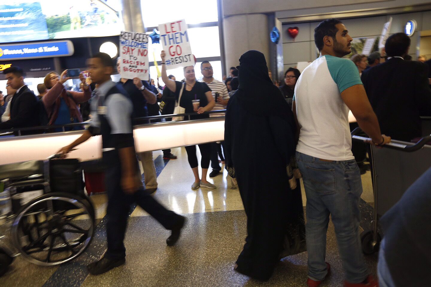 Passengers arrive at LAX as protests continue Sunday over President Trump's travel ban.