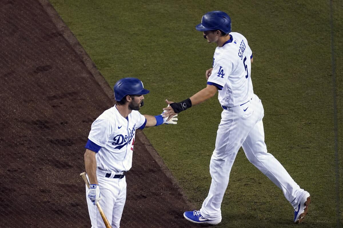 Dodgers shortstop Corey Seager, right, is congratulated by Chris Taylor after hitting a home run.