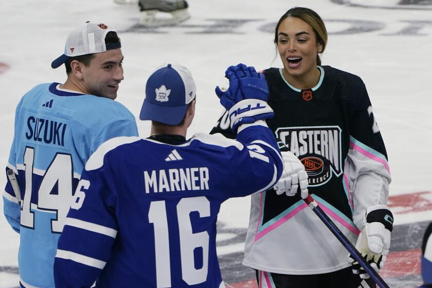 FILE - Montreal Canadiens' Nick Suzuki (14) and Toronto Maple Leafs' Mitchell Marner (16) congratulate Canadian hockey player Sarah Nurse after she scored a goal during the NHL All Star Skills Showcase, Friday, Feb. 3, 2023, in Sunrise, Fla. The best women's hockey players in the world aren't the only ones in the sport excited about the new pro league launching in January. Many of the biggest stars across the NHL are eager to see the Professional Women's Hockey League and hope it thrives. (AP Photo/Marta Lavandier, File)