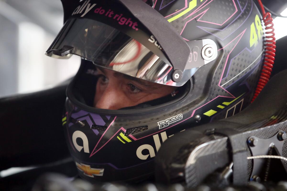 Jimmie Johnson waits in his car during a practice session at Auto Club Speedway on Friday.