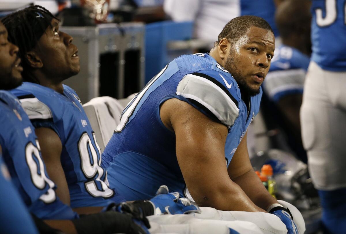 Detroit Lions defensive tackle Ndamukong Suh watches from the sideline during a wildcard playoff game against the Cowboys on Jan. 4.