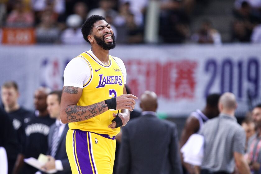 Lakers forward Anthony Davis grimaces after sustaining a thumb injury during the first half Saturday.