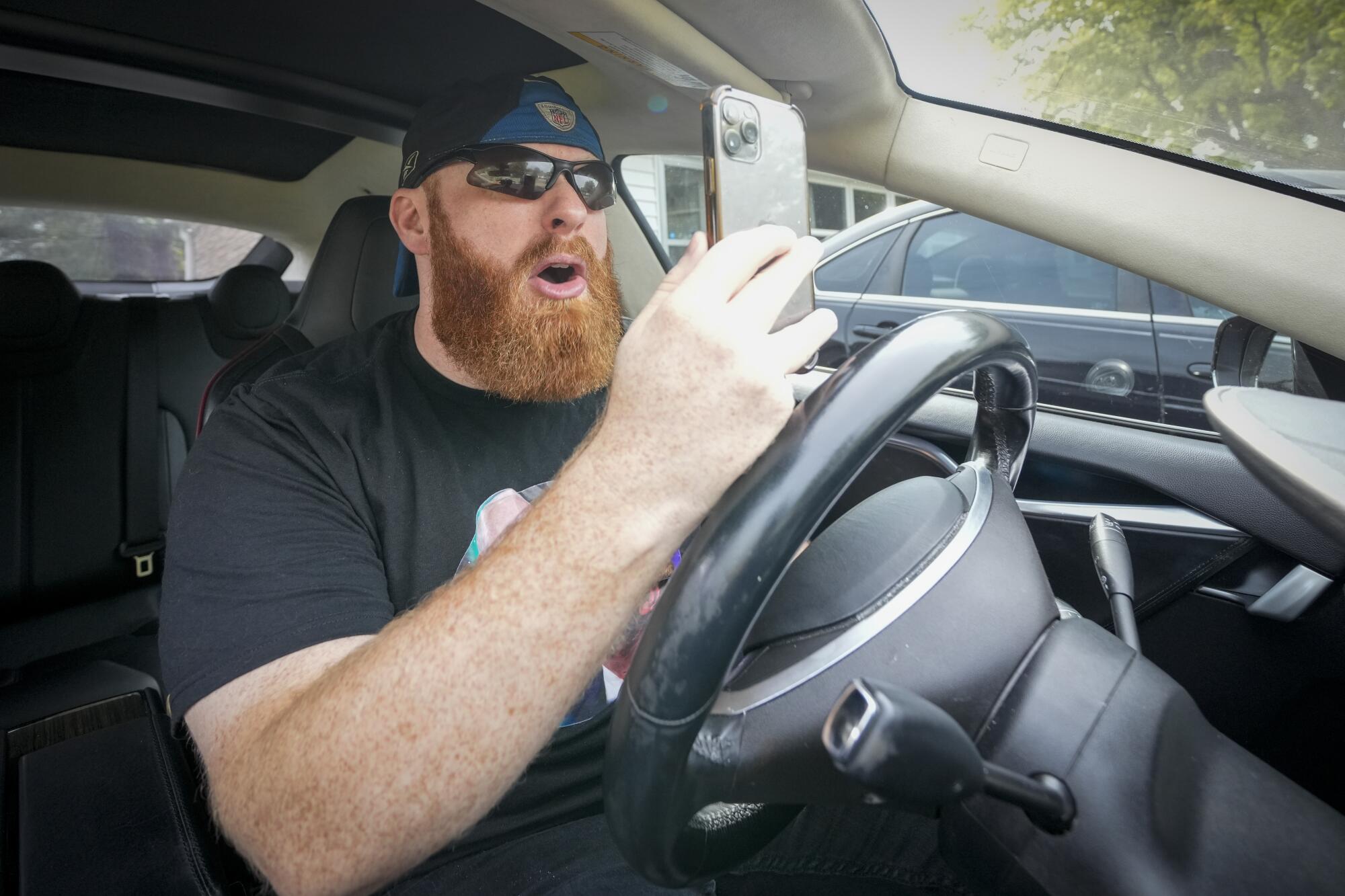 Brent Terhune recreates a recent video rant at his home in Greenwood, Ind.