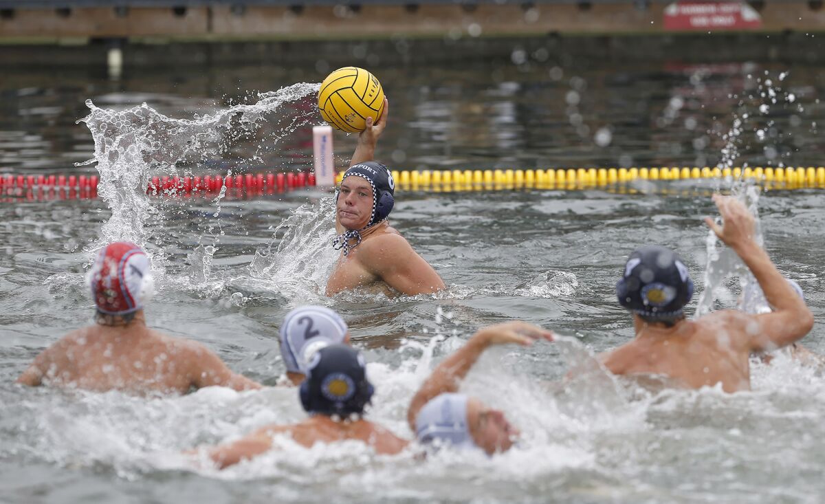 Newport Harbor's Owen Tift (8) takes a shot in traffic at Thursday's water polo showcase.