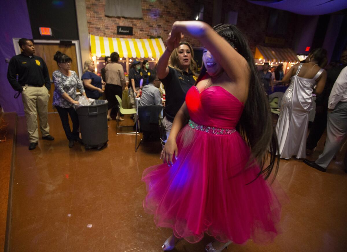 Aurora, 16, salsa dances with probation officer Angelica Arellano.