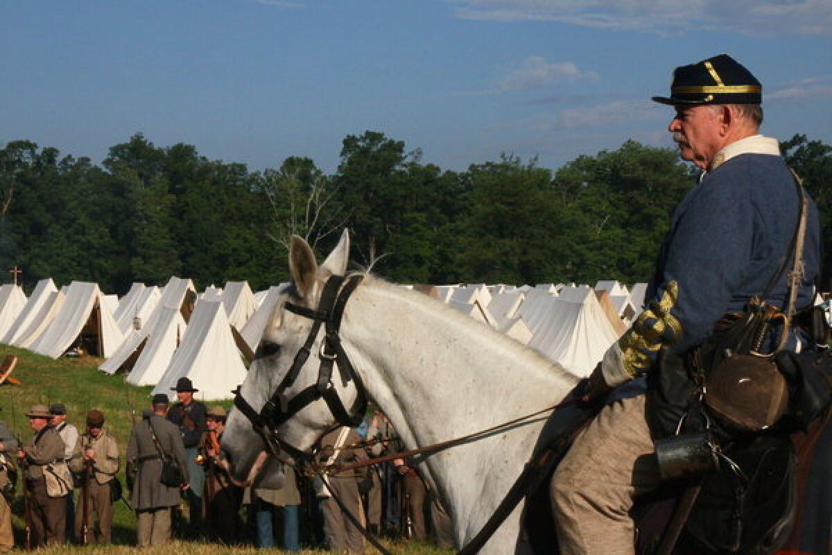 Confederate reenactors prepare to march off to battle in Gettysburg, Pa.