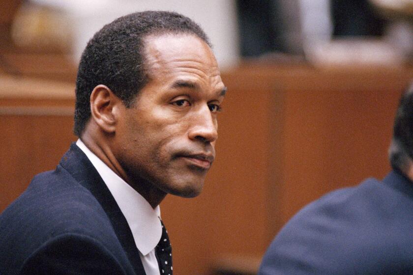 O.J. Simpson sits at his arraignment in superior Court in Los Angeles, July 22, 1994, where he pleaded "absolutely, 100 percent not guilty" on murder charges. (AP Photo/Pool/Lois Bernstein)