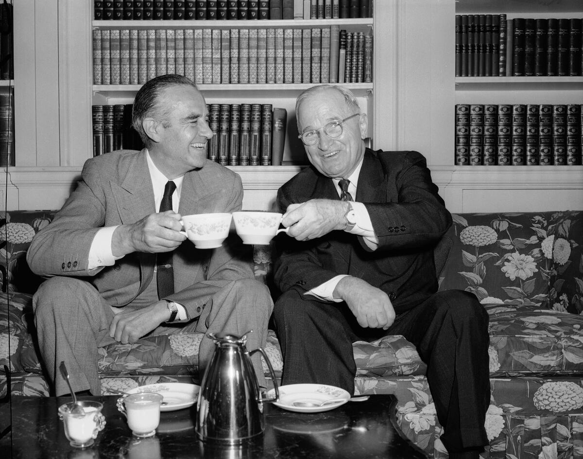 Former President Truman and New York Gov. Averell Harriman toast with coffee cups