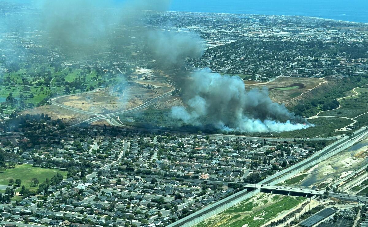 An aerial view of an 8.4-acre brush fire that broke out Sunday in Costa Mesa's Fairview Park.