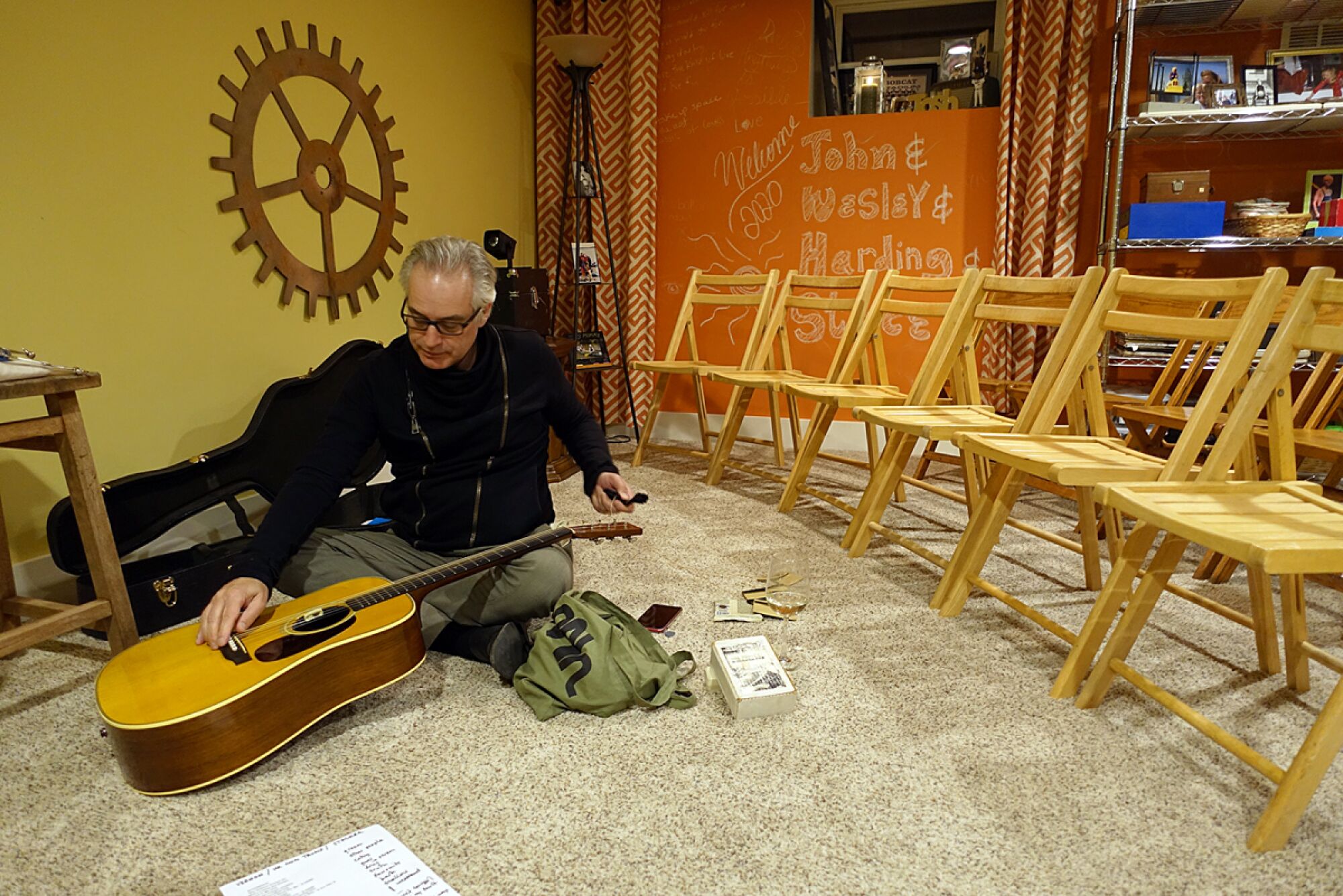 Wesley Stace restrings his guitar before a house concert in Columbus, Ohio