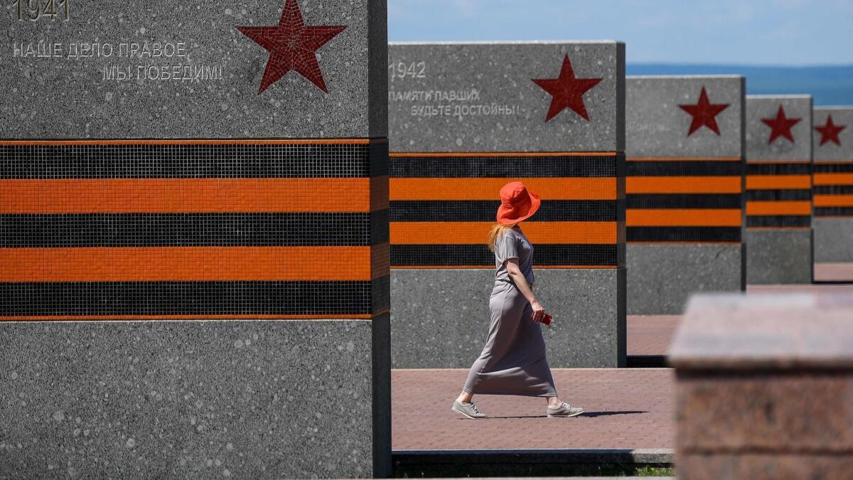 A tourist walks past a war memorial at Glory Square in Samara, Russia, on June 29.