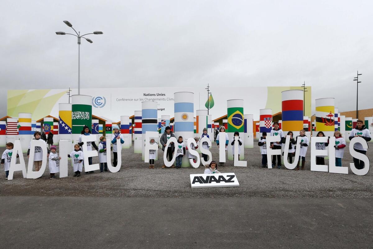 Children take part in an action organized by the Avaaz NGO, to promote 100% clean energy during the Paris climate summit.