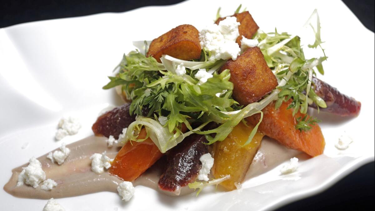 Our rendition of Chef Curtis Gamble's carrot salad with pomegranate curd, fresh cheese, chickpea fritters, bitter greens and harissa vinaigrette.