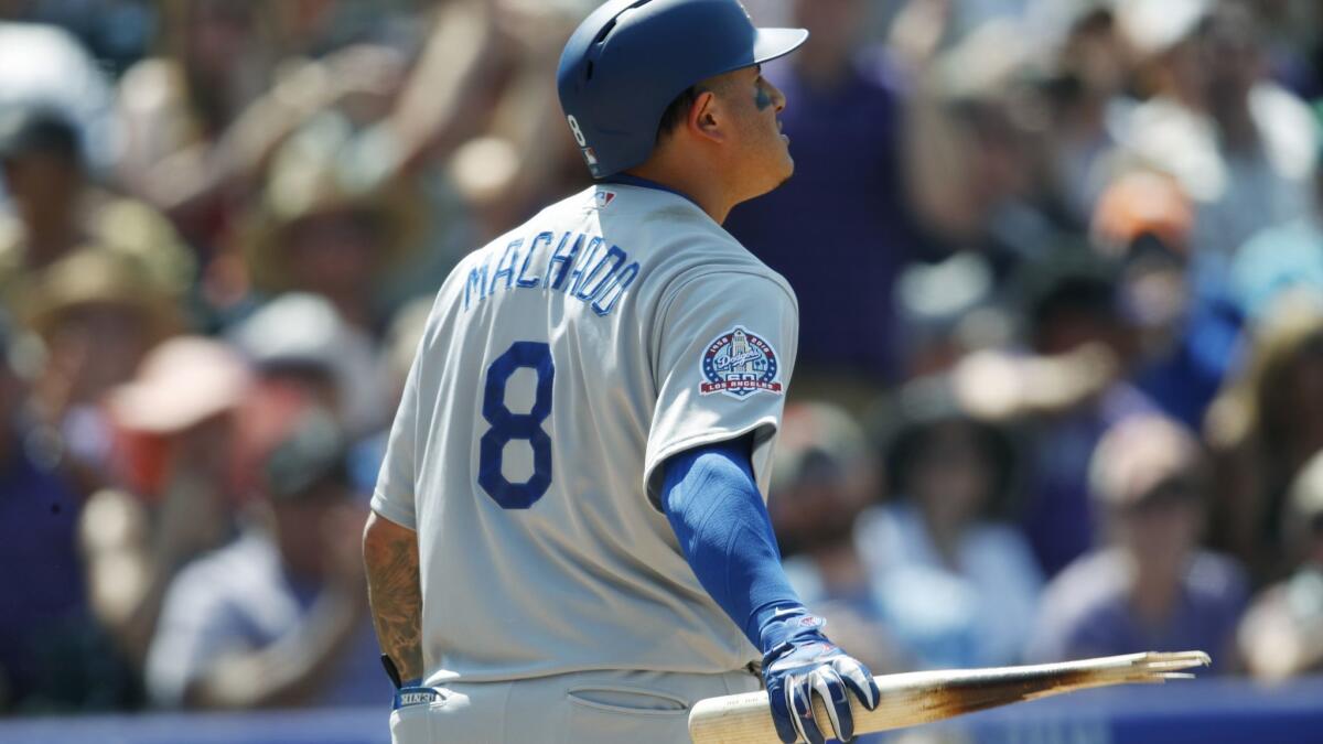 Dodgers' Manny Machado holds the barrel of the bat after snapping it in half following his strike out against Colorado Rockies on Sunday. The Dodgers loss 4-3.
