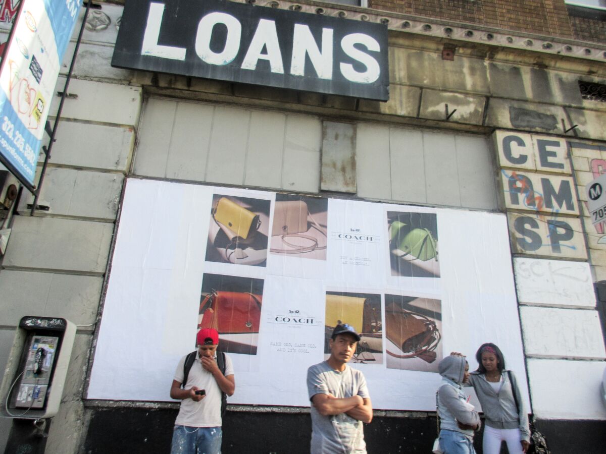 Las Fotos Project participant Nimsy Rivas, 17 at the time, juxtaposed a sign for loans with an ad for Coach in a photo she titled "A Day in South Los Angeles."  