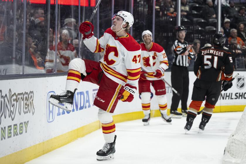 Calgary Flames center Connor Zary (47) celebrates his goal against the Anaheim Ducks during the second period of an NHL hockey game Friday, April 12, 2024, in Anaheim, Calif. (AP Photo/Kyusung Gong)