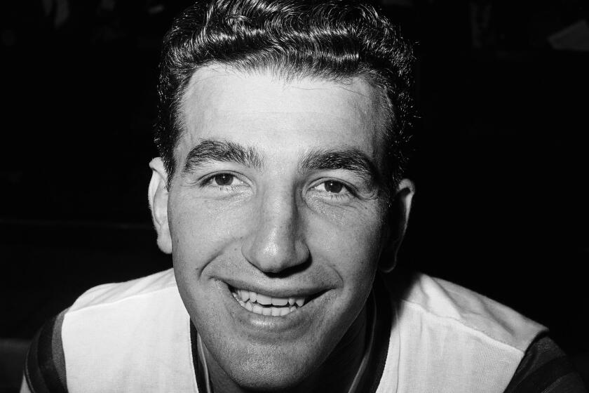 Syracuse Nationals center Dolph Schayes smiles in New York on Nov. 14, 1961. Schayes, a 12-time All-Star and NBA Hall of Famer, died at 87.
