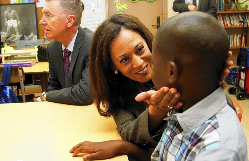 California Atty. Gen. Kamala D. Harris talks to a fifth-grade student while she and L.A. Unified Supt. John Deasy tour classes on the first day of school at Baldwin Hills Elementary.