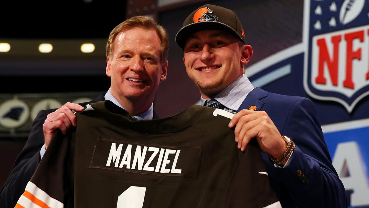 Former Texas A&M quarterback Johnny Manziel poses with NFL Commissioner Roger Goodell after being selected by the Cleveland Browns in the NFL draft.