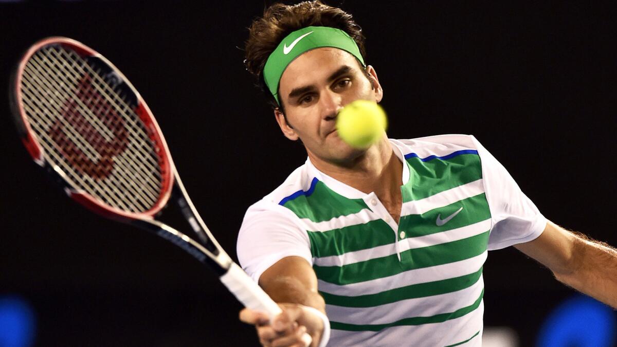 Roger Federer volleys a shot against Grigor Dimitrov during a third-round match at the Australian Open on Friday.