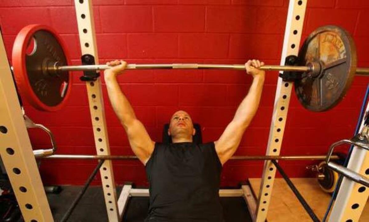 Aaron Snyder of San Diego bench presses to control his diabetes through diet and strength and conditioning at his home on October 20, 2009 in the Mission Bay area. Snyder was diagnosed 10 years ago, he lost 50 pounds the first year and 10 more later. Now He sticks to a low-carb diet and works out everyday without taking medication.