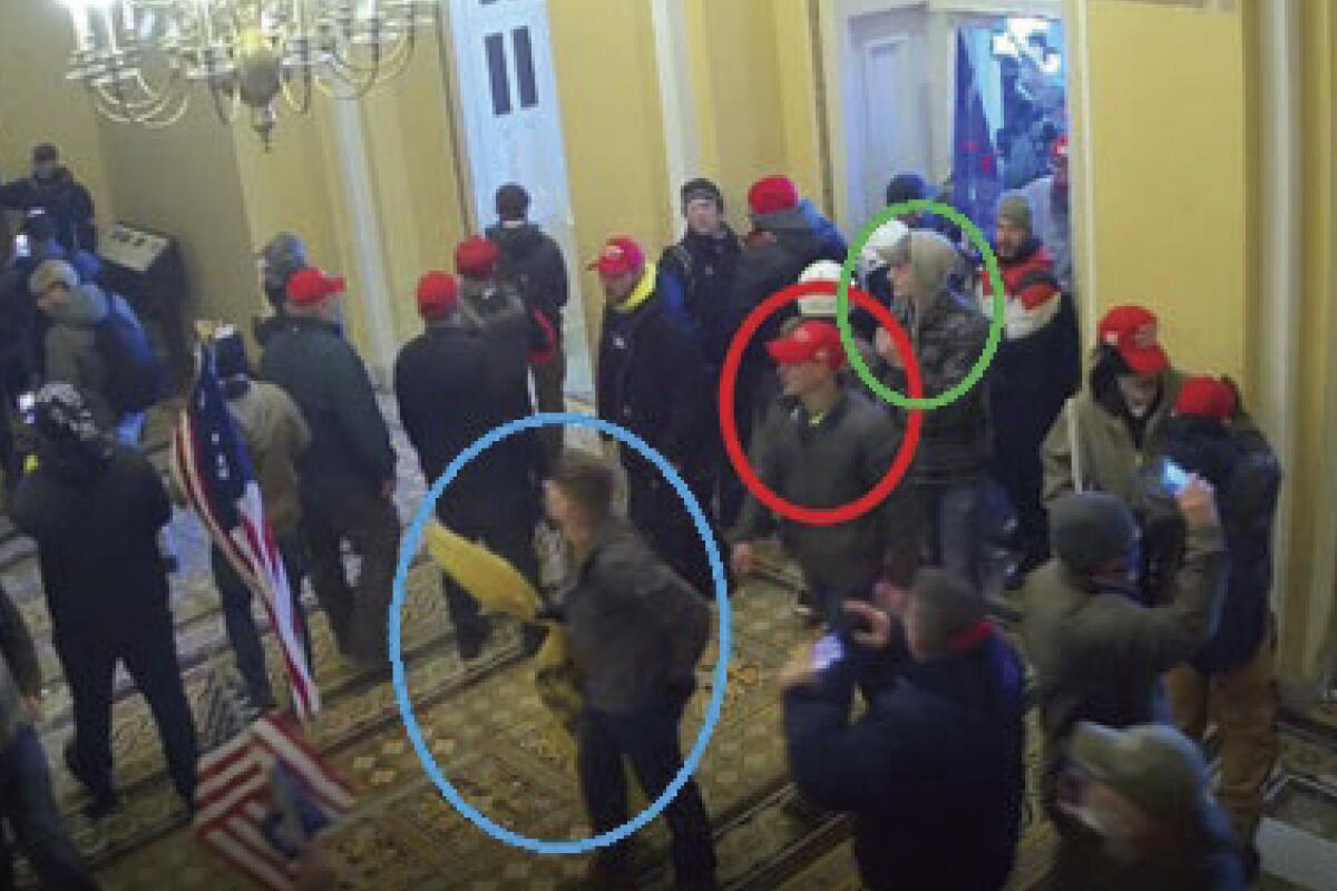 Three Marines are circled in an image from security video inside the Capitol